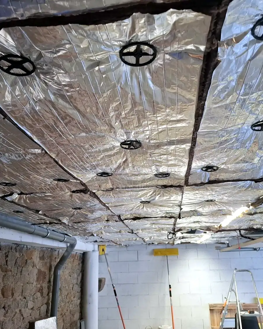 Plafond de garage isolé par panneaux isolants à face aluminium, mur en pierre, en Ille-et-Vilaine (35) – Galais Isolation
